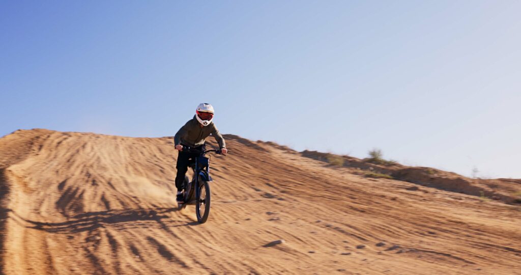 Person, driving and motorbike on sand for sports with cross country training, performance technique.